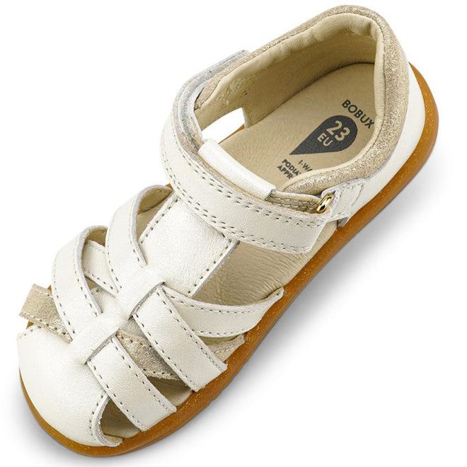The Bobux iwalk Cross Jump Sandal Moon Pearl Closed Toe 636708 is a white kids' sandal with woven leather straps, a hook-and-loop closure, tan suede heel lining, and a light brown rubber sole. Insole size shown is 33 EU., 9420068516335, 9420068516342, 9420068516359, 9420068516366, 9420068516373