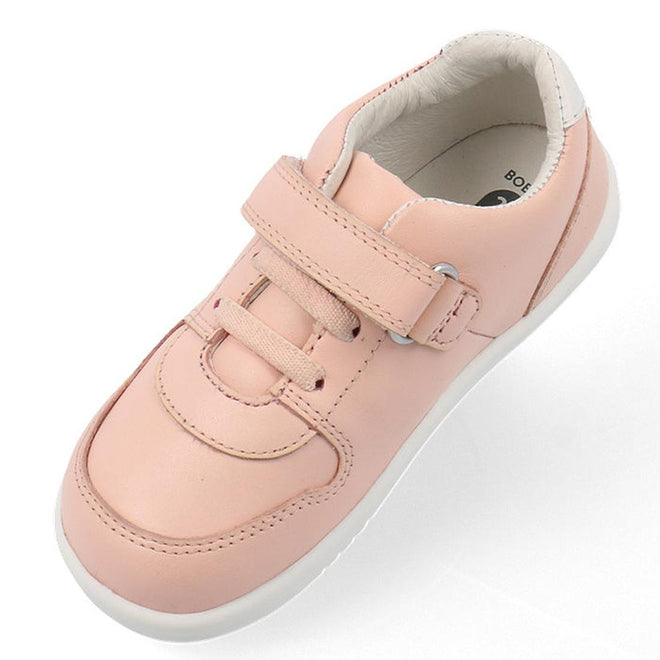 The Bobux Kids IWalk IW Comet Sneaker in Seashell Pink/White features a leather upper, flexible white sole, hook-and-loop strap, and pink laces, shown as a single children's sneaker on a white background., 9420075706286, 9420075706293, 9420075706309, 9420075706316, 9420075706323