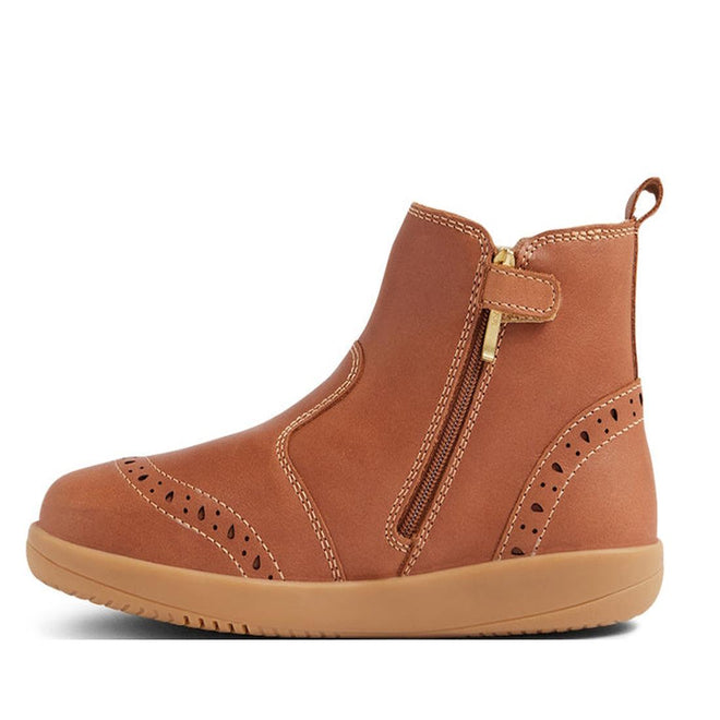 The Bobux Kid+ KP Billie 2 II Girls Leather Boot in Caramel Tan is a kids' ankle boot featuring decorative perforations, tan stitching, a flexible sole, side zipper with gold pull tab, and a back pull loop., 9420074867179, 9420074867186, 9420074867193, 9420074867209, 9420074867216, 9420074867223, 9420074867230