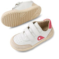 The Bobux KP Kids Plus Champ II Sneaker White Raspberry Juniors features white leather, beige soles, pink side and heel accents, adjustable Velcro straps, toe perforations, and a flexible sole—one shoe upright, the other showing its bend., 9420074829856, 9420074829863, 9420074829870, 9420074829887, 9420074829894