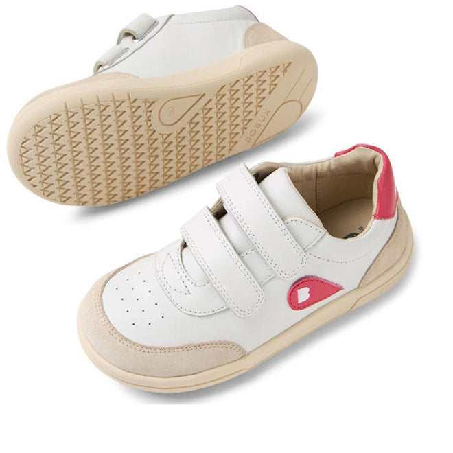 The Bobux KP Kids Plus Champ II Sneaker White Raspberry Juniors features white leather, beige soles, pink side and heel accents, adjustable Velcro straps, toe perforations, and a flexible sole—one shoe upright, the other showing its bend., 9420074829856, 9420074829863, 9420074829870, 9420074829887, 9420074829894