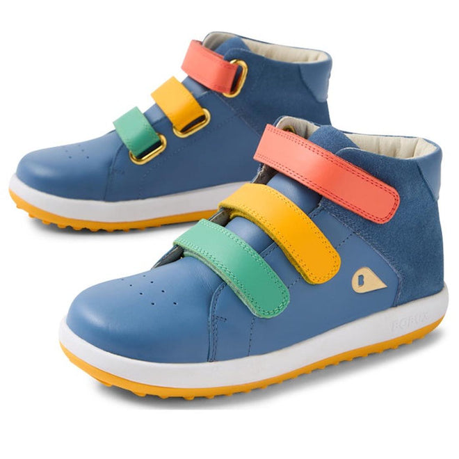 The Bobux KP Kids Plus Juniors Gamepoint Leather Boot in Coronet Blue features three adjustable straps in red, yellow, and green, white soles, and a durable rubber outsole.