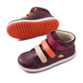 The Bobux KP Kids Plus Juniors Gamepoint Leather Boot in Fig Purple features two children's sneakers with pink and orange adjustable straps, white rubber soles, and orange tread; one shoe is upright, the other shows the sole., 9420074815330, 9420074815347, 9420074815354, 9420074815361, 9420074815378, 9420074815385, 9420074815392
