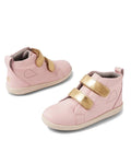 The Bobux KP Grass Court High II Boot Ballet Pink Juniors are two light pink kids’ leather high-top sneakers with gold adjustable straps, white soles, and subtle stitching details, displayed on a white background.