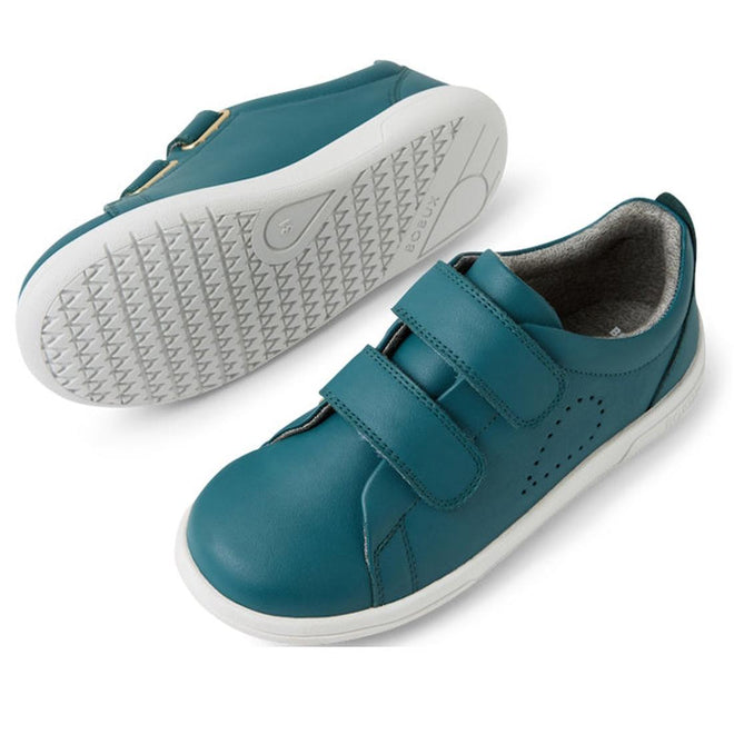 A pair of Bobux KP Kids Plus Grass Court 2 II Leather Sneakers in Mediterranean Green with white durable soles. One shoe stands upright showing two adjustable straps, while the other displays the textured sole., 9420074859303, 9420074859310, 9420074859327, 9420074859334, 9420074859341, 9420074859358, 9420074859365