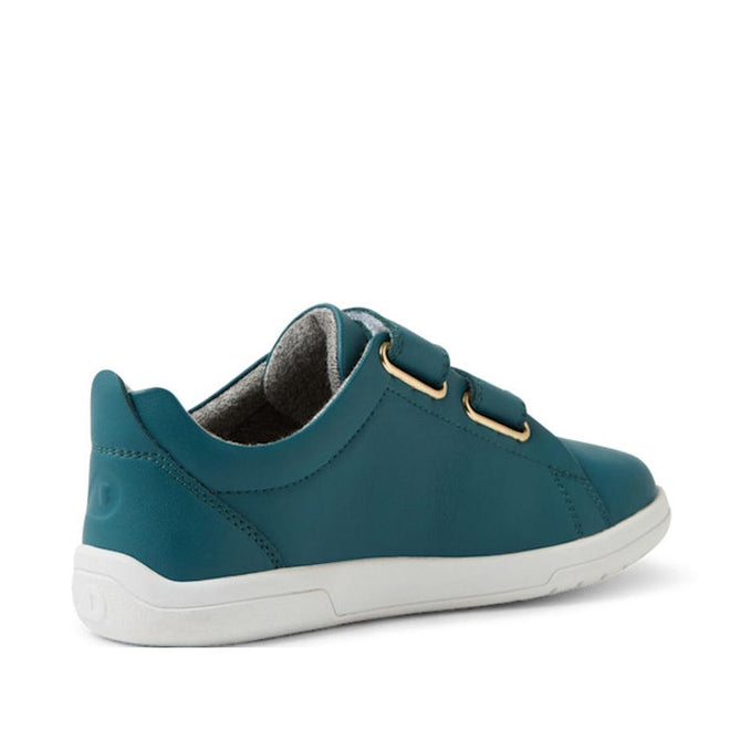 The Bobux KP Kids Plus Grass Court 2 II Leather Sneaker in Mediterranean Green is a low-cut kids’ shoe with a smooth finish, adjustable Velcro straps, gold eyelets, and a white durable sole, shown angled from the back right side., 9420074859303, 9420074859310, 9420074859327, 9420074859334, 9420074859341, 9420074859358, 9420074859365