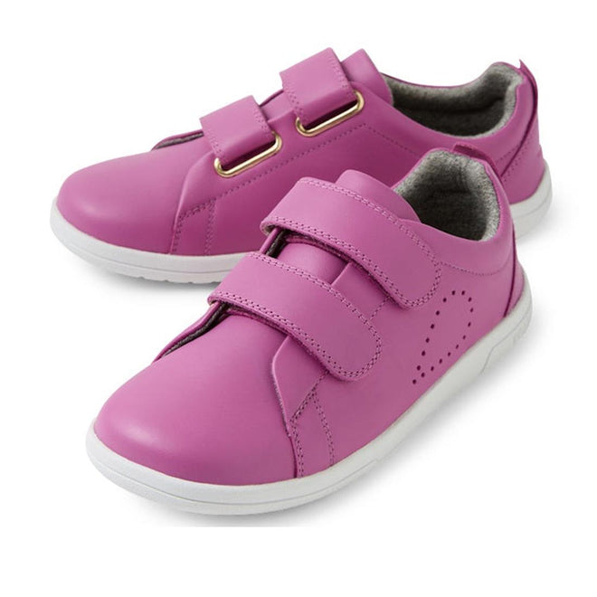 A pair of Bobux KP Kids Plus Grass Court II Leather Sneakers in Cattleya Orchid Purple, featuring white soles and two Velcro straps per shoe, displayed on a white background.