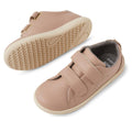 The Bobux KP Kids Plus Grass Court 2 II Leather Sneaker in Warm Taupe features double Velcro straps, rubber soles, a Bloom EVA footbed, and a soft gray lining. One shoe displays the side view; the other highlights the textured sole pattern., 9420074831460, 9420074831477, 9420074831484, 9420074831491, 9420074831507