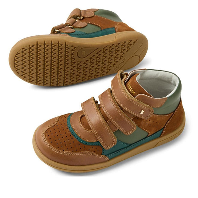 The Bobux KP Kids Plus Harley Ankle Leather Boot Caramel Tan Juniors features brown, green, and tan colors with perforated detailing, adjustable straps, and a durable sole. One boot is shown upright; the other displays its tread pattern., 9420074833716, 9420074833723, 9420074833730, 9420074833747, 9420074833754