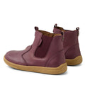 A pair of Bobux KP Kids Plus Jodhpur 2 II Juniors leather boots in fig purple, featuring elastic side panels, pull tabs, and a flexible tan rubber sole with the BOBUX brand name on the side., 9420074834980, 9420074834997, 9420074835000, 9420074835017, 9420074835024, 9420074835031, 9420074835048