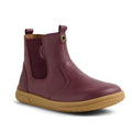 The Bobux KP Kids Plus Jodhpur 2 II Juniors Leather Boot in Fig Purple features a kids' leather design with a flexible tan sole, side elastic panel, and back pull tab, shown against a white background.