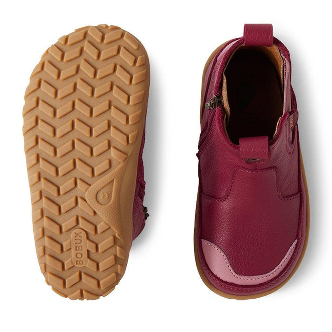 The Bobux KP Kids Plus Trail Leather Boot Juniors in Beaujolias Purple Alpha features tan rubber soles, a zipper closure, barefoot-shaped toe box for natural movement; left shoe shown from the bottom for tread and right highlights the design., 9420068563841, 9420068563858, 9420068563865, 9420068563872, 9420068563889, 9420068563896, 9420068563902