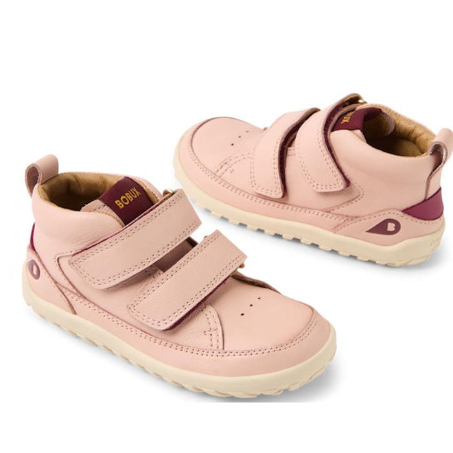 The Bobux KP Kids Plus Trek Leather Boot Juniors in Cameo Rose Pink Alpha features beige soles, double Velcro straps, maroon accents on the tongue and heel, and a barefoot-shaped toebox, all shown on a white background.