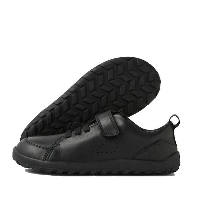 The Bobux Kid+ Prime Alpha Black School Leather Sneaker Shoe for children features a barefoot-shaped toe-box, thick textured rubber soles, Velcro and adjustable straps, and a heel pull tab; one shoe is upright, the other shows its sole., 48416, 9420074804617, 9420074804624, 9420074804631, 9420074804648, 9420074804655, 9420074804662