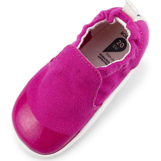 The Bobux Xplorer Scamp Crawler Fuchsia Pink 501708 is a bright pink toddler summer shoe with a flexible sole, elasticized collar, canvas upper, and white outsole. Viewed from above, it shows the rounded toe and size marking inside., 32238, 9420068534599, 9420068534605, 9420068534612