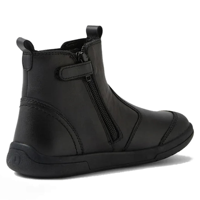 The Bobux Kid+ Black School Leather Boot Jodhpur II Black Sole Junior features a rounded toe, flat sole, side zipper, and hook-and-loop strap—shown from a rear side angle on white background. Ideal as stylish school shoes., 51128, 51129, 51130, 51131, 51132, 51133, 51134, 51128, 9420074842091, 51130, 9420074842114, 9420074842121, 9420074842138, 9420074842145