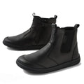The Bobux Kid+ Black School Leather Boot Jodhpur II Black Sole Junior features black leather, side zippers, pull tabs, elastic panels, and sturdy rubber soles, shown against a white background., 51128, 51129, 51130, 51131, 51132, 51133, 51134, 51128, 9420074842091, 51130, 9420074842114, 9420074842121, 9420074842138, 9420074842145