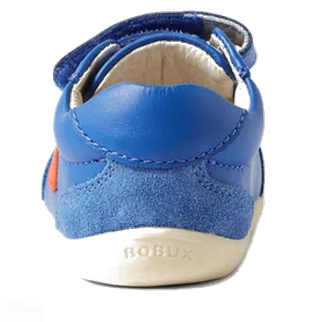 The Bobux Step Up SU Champ II Sneaker in Olympian Blue is a toddler’s first walker with a suede heel, Velcro strap, and "BOBUX" embossed on the white sole—offering both comfort and style for little ones., 9420068552319, 9420068552326, 9420068552333