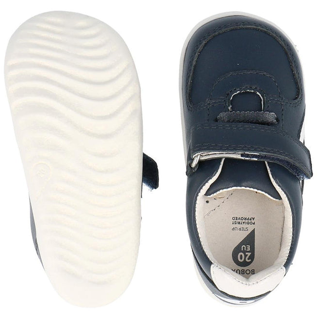The Bobux Step Up SU Toddlers Leather Sneaker Comet Navy 734603 is shown in top and bottom views, featuring navy blue leather, flexible white soles, a hook-and-loop strap, detailed stitching, and EU size 20 marked inside., 9420075706248, 9420075706255, 9420075706262, 9420075706279