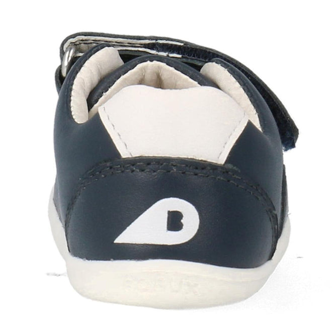 A close-up rear view of the Bobux Step Up SU Toddlers Leather Sneaker Comet Navy 734603, showing its dark blue and white design, white logo on the heel, visible ankle collar, flexible sole, and a side hook-and-loop strap., 9420075706248, 9420075706255, 9420075706262, 9420075706279