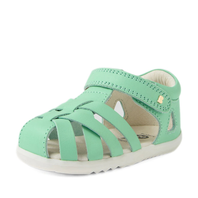 A stylish Bobux Step Up SU Tropicana II Mint Jelly Green Closed Toe Sandal for toddlers, featuring a mint green leather finish, woven straps, gold-tone stud detail on the side, a closed toe design, velcro strap fastening, and a white sole., 9420074809803, 9420074809810, 9420074809827