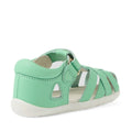 The Bobux Step Up SU Tropicana II Mint Jelly Green Closed Toe Sandal is a children’s sandal in mint green, featuring a closed heel, open sides, and an adjustable Velcro strap as seen from a rear side angle. These stylish leather sandals for toddlers include a white sole and a light-colored inner lining, providing classic closed-toe comfort perfect for active little feet., 9420074809803, 9420074809810, 9420074809827