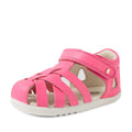 A small, vibrant pink Bobux Step Up SU Tropicana II Pink Lemonade Closed Toe Sandal with a protective closed toe, white sole, and Velcro strap. This sandal features cut-out sides and decorative stitching, designed as stylish closed-toe sandals for young children., 9420074809902, 9420074809919, 9420074809926