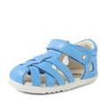 A single Bobux Step Up SU Tropicana II Baltic Sea Blue Closed Toe Sandal designed for toddlers, featuring a light blue leather upper with a closed toe, open sides, Velcro strap, soft white sole, and small decorative cutouts—offering comfort and style for little feet and perfect for fans of the beloved Tropicana sandals., 9420074809957, 9420074809964, 9420074809971
