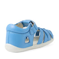 The Bobux Step Up SU Tropicana II Baltic Sea Blue Closed Toe Sandal is shown from a rear side angle. This toddler leather sandal features a closed heel, open sides, white sole, and a convenient hook-and-loop strap inspired by Bobux Tropicana sandals for easy fastening., 9420074809957, 9420074809964, 9420074809971