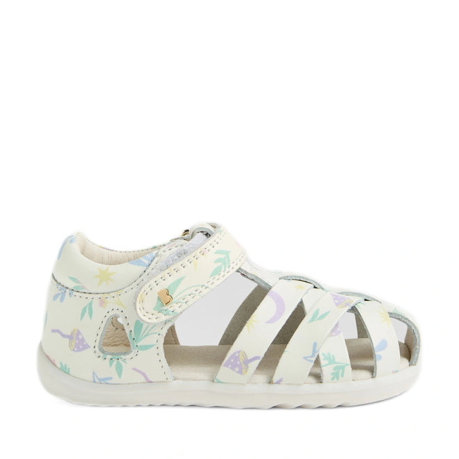 Bobux Step Up SU Tropicana II White Floral Closed Toe Sandal for toddlers, inspired by the classic Bobux Tropicana, features a Velcro strap and a closed toe with open sides. Crafted from high-quality leather, it showcases a pastel floral pattern with stars, leaves, and mushrooms in blue, purple, and yellow. The sandal is finished with a lightly textured white sole for a clean look., 9420074810007, 9420074810014, 9420074810021