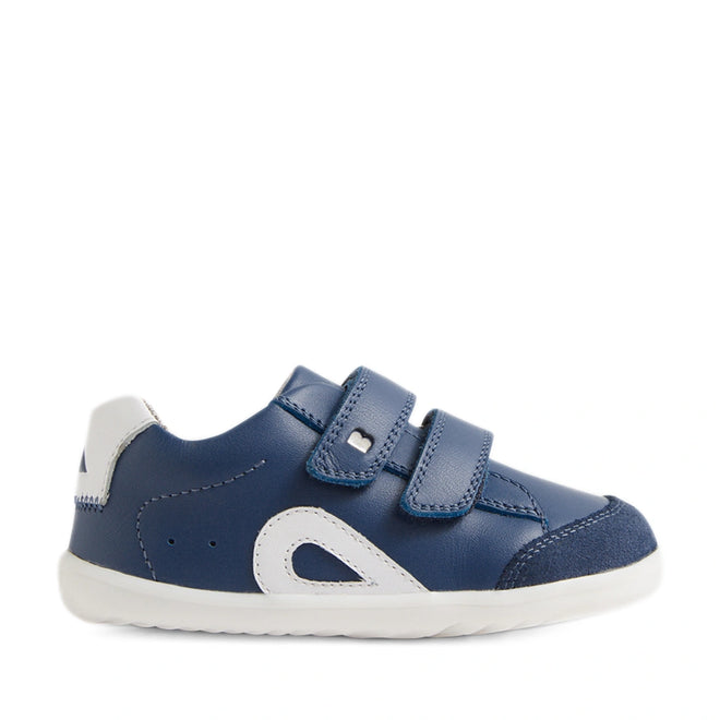 The Bobux SU Step Up Blaze Leather Toddlers Sneaker in Vintage Indigo is a blue and white first walking shoe for toddlers, featuring two velcro straps, white accents, a white rubber sole, and a rounded toe. It is shown in profile facing right on a plain white background., 9420074848758, 9420074848765