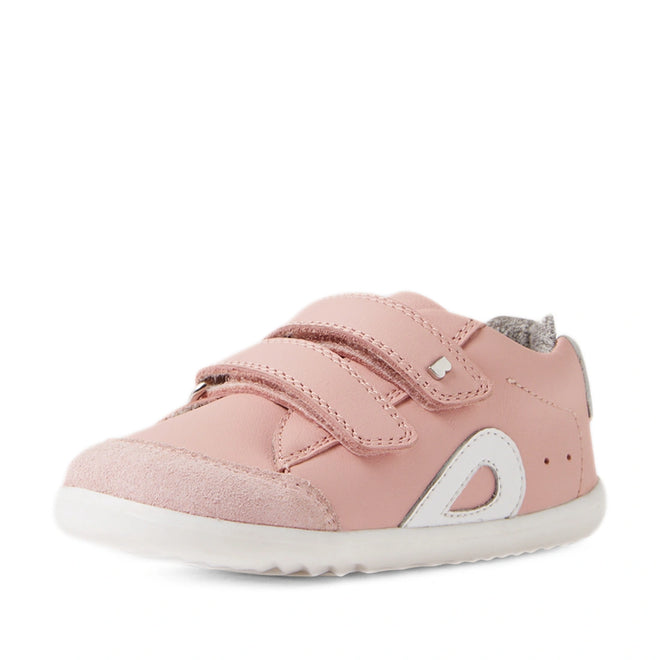 The Bobux SU Step Up Blaze Leather Toddlers Sneaker in Ballet Pink features two Velcro straps, white accents, a gray fabric lining, and a white rubber sole. Shown on a white background, these adorable sneakers are perfect as first walking shoes or for little ones who love cute pink footwear., 9420074848901