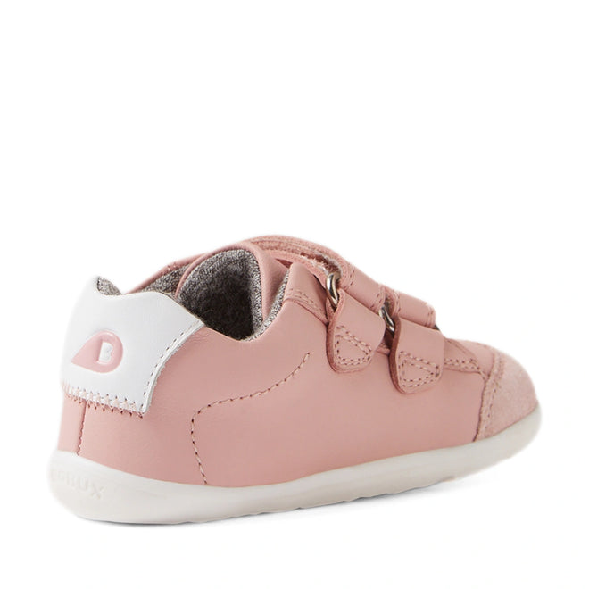 Introducing the Bobux SU Step Up Blaze Leather Toddlers Sneaker in Ballet Pink—a stylish first walking shoe for children, shown from a rear side angle on a white background. This sneaker features two velcro straps, a crisp white heel accent, and a soft white sole., 9420074848901