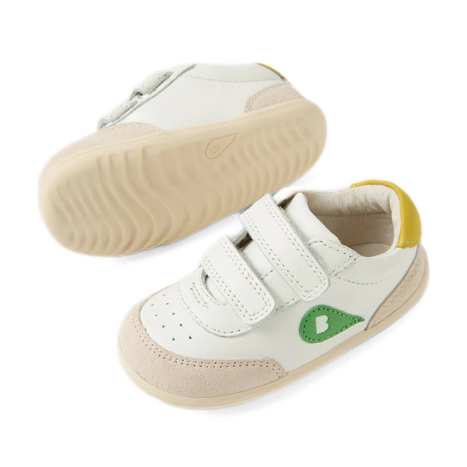 The Bobux Step Up SU Champ Sneaker First Walker White Green features white leather uppers with beige soles, a convenient hook and loop strap, a green heart patch on the side, and yellow detailing on the heel—perfect kids’ sneakers for first walkers. Shown from both side and bottom views., 9420074861795, 9420074861801, 9420074861818