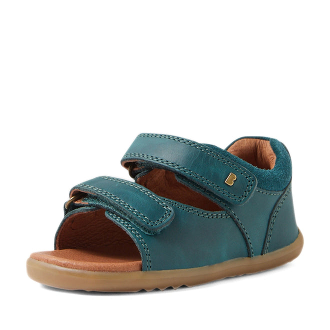 A single Bobux SU Step Up Driftwood First Walker Open Toe Sandal in Mediterranean Green—with two adjustable Velcro straps, a tan rubber sole, open toe design, and brown inner lining—ideal as first walking shoes or boys’ leather sandals, is displayed against a white background., 9420074807458, 9420074807465, 9420074807472