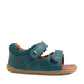The Bobux SU Step Up Driftwood First Walker Open Toe Sandal in Mediterranean Green is a children’s sandal featuring two adjustable Velcro straps, a cushioned brown insole, and a flexible light brown rubber sole—ideal as boys’ leather sandals or first walking shoes., 9420074807458, 9420074807465, 9420074807472