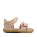 Bobux Step Up Grass Logan First Walker Sandal in Cameo Rose Pink, featuring light pink leather with perforated decorative patterns, velcro straps at the ankle and toe, and a tan rubber sole, shown from the side on a white background. Perfect as first walker sandals for little ones.