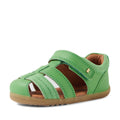 The Bobux Step Up Sandal Roam Closed Toe Sandals Retro Green—toddler sandals ideal as first walkers—feature a closed toe, velcro strap, premium leather upper with suede accents, and a durable rubber sole, shown here against a white background., 9420074807205, 9420074807212, 9420074807229