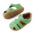 A pair of Bobux Step Up Sandal Roam Closed Toe Sandals in Retro Green, featuring velcro straps and brown rubber soles with a leather closed-toe design, are displayed from side and top angles against a white background., 9420074807205, 9420074807212, 9420074807229