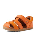 The Bobux Step Up Sandal Roam Closed Toe Sandals in Orange Peel are toddler leather sandals featuring multiple straps, a Velcro closure, suede accents, and a brown rubber sole. These stylish orange sandals are displayed at an angle on a white background., 9420074807250, 9420074807267, 9420074807274