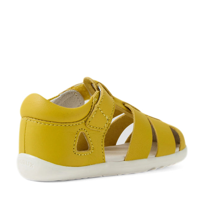 The Bobux Step Up SU Toddlers Tidal Mango Mint Yellow Closed Toe Sandal is crafted from water-friendly yellow leather and features a closed heel, open toe, white sole, and an easy Velcro strap. Viewed from the back right side, it’s an ideal first walker sandal for active little feet., 9420074808639, 9420074808646, 9420074808707
