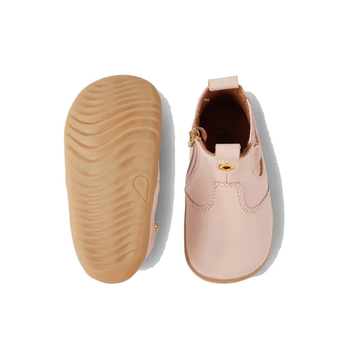 The Bobux Step Up Jodhpur Boot Cameo Rose Pink is a pair of unisex first walker boots in light pink leather, featuring a soft rubber sole and a small gold side detail. Shown from both top and bottom views on a white background., 9420068539471, 9420068539488, 9420068539495, 9420068539501