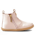 The Bobux Step Up Jodhpur Boot Cameo Rose Pink is a light pink unisex leather toddler boot with a tan rubber sole, side zipper with gold pull, decorative stitching, and pull tabs—ideal as stylish first walkers., 9420068539471, 9420068539488, 9420068539495, 9420068539501