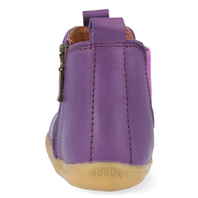 The Bobux Step Up Jodphur Boot Indigo Purple is a unisex children's boot in purple leather, seen from the back, with brown stitching, a side zipper, light brown sole embossed "BOBUX" on the heel—perfect for first walkers., 9420075788879, 9420075789456, 9420075788916, 35573