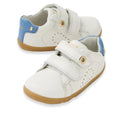 The Bobux SU Step Up Maverick Leather Toddlers Sneaker in White Coronet Blue features gum soles, blue heel accents, perforated sides for breathability, and double Velcro straps—ideal as first walker shoes for toddlers.