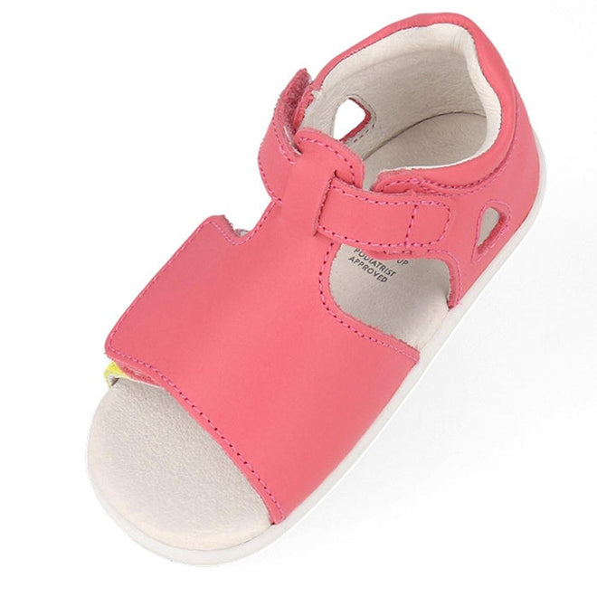 The Bobux Step Up Mirror Leather Sandal in Guava Bright Pink Rainbow (727341) is shown from above with an open toe, white sole, and adjustable Velcro strap—ideal first walker sandals for toddlers., 9420075704640, 9420075704657, 9420075704664, 9420075704671