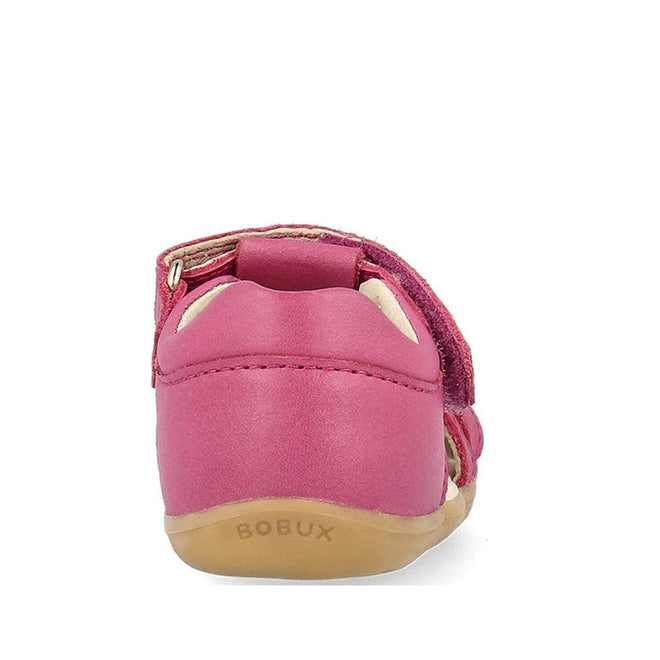 Rear view of the Bobux Step Ups Cross Jump Mauve Haze 731116 closed toe sandal for kids, featuring a pink leather upper, tan sole, embossed BOBUX logo on the heel, and a visible Velcro strap. Plain white background., 9420075773622, 9420075773288, 9420075769649, 9420075768871