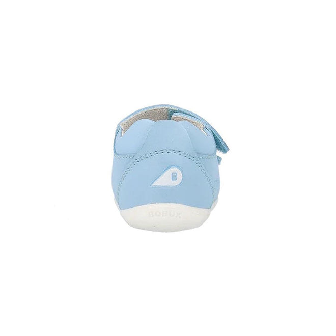 The Bobux Step Up - Topia Sandal First Walking Glacial Blue 751303 is a light blue leather baby sandal with a white sole, small B logo, blue side strap, and is shown from the back on a white background., 39287, 9420075763760, 9420075763678, 9420075763777