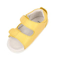 The Bobux Step Up - Topia First Walker Sandal 751304 in Pineapple Yellow features two adjustable Velcro straps and a white cushioned sole, making it perfect as a first walking sandal for children. Shown on a white background., 9420075763722, 9420075763654, 9420075764422, 9420075764446