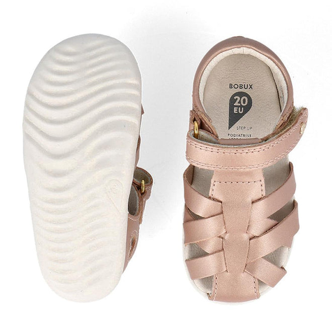 A pair of Bobux Step Up Tropicana II Rose Gold Sandal 732318 Quick Dry toddler sandals feature a light pink closed-toe design and white textured sole; one sandal shows the insole label, the other highlights quick dry leather and unique sole pattern., 9420075778528, 9420075772502, 9420075772175, 9420075772731
